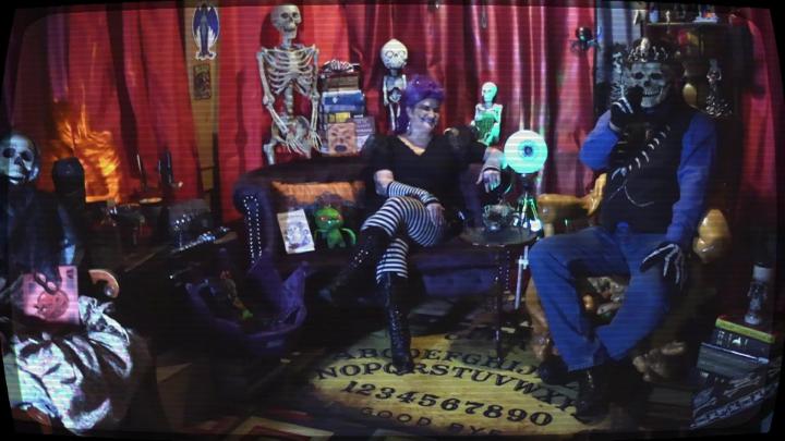 Red curtain background with various horror related figures.