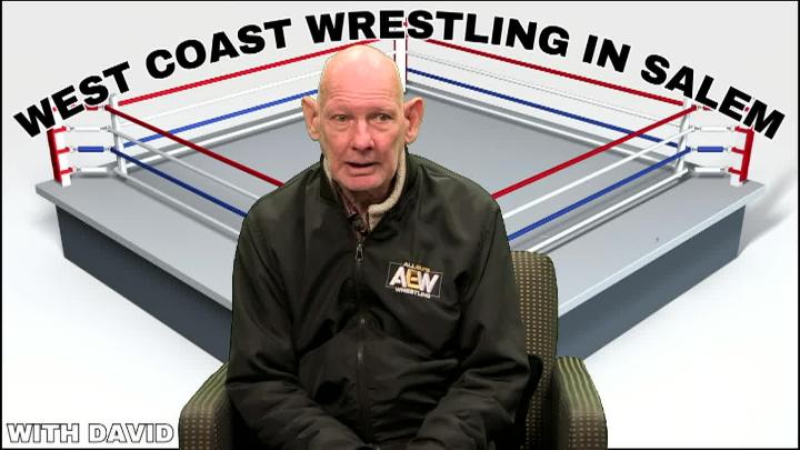 Man in a black jacket sitting in front of a wrestling ring. West Coast Wrestling in Salem arched over